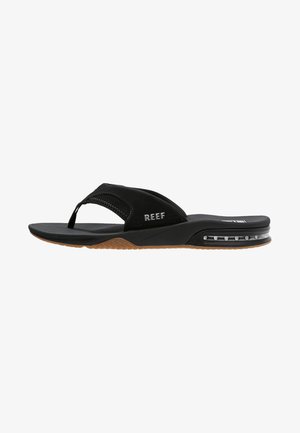 Black flip-flop sandal with a soft strap, textured footbed, and rubber sole featuring a visible air pocket. Brand logo visible on strap.