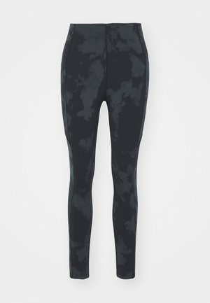 Juodos leggingos su lygiu paviršiumi, turinčios subtilų tamsų dažymo modelį. Aukštu liemeniu ir šoninėmis juostomis, kurios suteikia universalų įvaizdį.