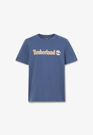 Blaues T-Shirt mit kurzen Ärmeln und Rundhalsausschnitt, mit beigem Timberland-Logo und Baum-Emblem, zentriert auf der Brust.