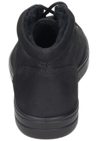 Svart läderankelboot med rund form, mjukt inre foder och gummisula. Har minimal sömnad och en strömlinjeformad design.