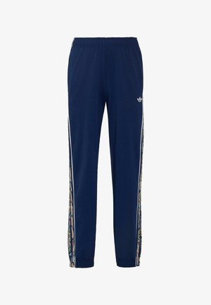 Granatowe spodnie dresowe z elastycznym pasem, elastycznymi mankietami, bocznymi paskami z kolorowym wzorem paisley oraz małym białym logo Adidas na lewym udzie.