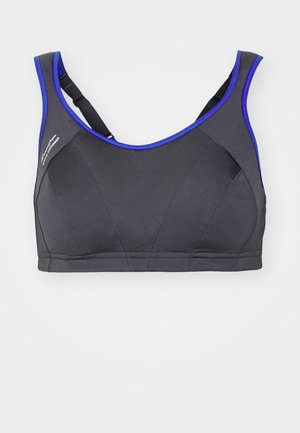 Sportovní podprsenka v černé tkanině s modrým lemováním, s designem racerback, hladkým povrchem a zesíleným šitím. Bez viditelné kovové součásti.