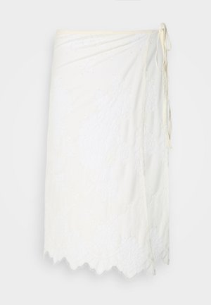 White wrap skirt with floral lace embroidery, scalloped hem, and side tie closure, displayed on a plain background.