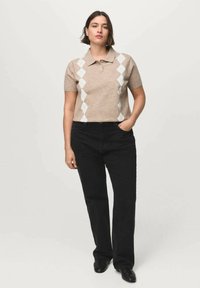 Beige polo shirt with a diamond pattern in white, paired with black trousers. The fabric has a textured look, and the cut is fitted.