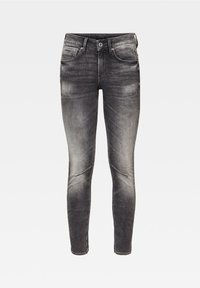 Jeans ajustados de mezclilla, con un color negro desgastado, un ligero desgaste y detalles de costura en las rodillas. Incluyen cinco bolsillos y un cierre de botón.