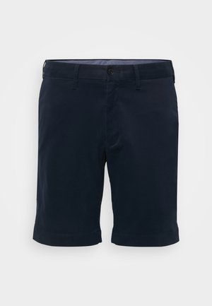 Shorts din bumbac bleumarin, cu croi drept, închidere cu un singur nasture și manșete răsucite. Textură netedă, cu bucle pentru curea și buzunare laterale.