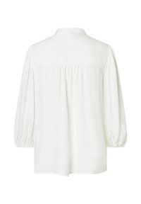 White blouse with long puff sleeves, soft fabric, buttoned back collar, and gathered detailing along the back for a relaxed fit.