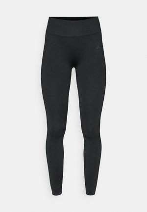 Zwarte legging met een hoge tailleband, gemaakt van glad, rekbaar stof. Voorzien van minimale naden en een subtiel logo op de heup.