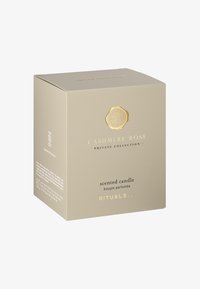 Kashmirros doftljus i en krämfärgad box. Guldprägling med detaljer som visar varumärkesnamnet, produkttypen och dekorativa accenter.