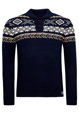 Granatowy dziergany sweter z białymi i żółtymi geometrycznymi wzorami na klatce piersiowej i ramionach, z dwuguzikowym kołnierzem.