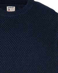 Navyblaues Strickpullover mit strukturiertem Muster, ausgestattet mit einem gerippten Rundhalsausschnitt und einem Markenlabel am Kragen.