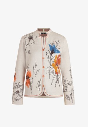 Kremowy kardigan z kwiatowym wzorem w kolorach niebieskim, pomarańczowym i czarnym. Posiada okrągły dekolt, zapinany na guziki z przodu oraz kontrastowe przeszycia wzdłuż krawędzi.