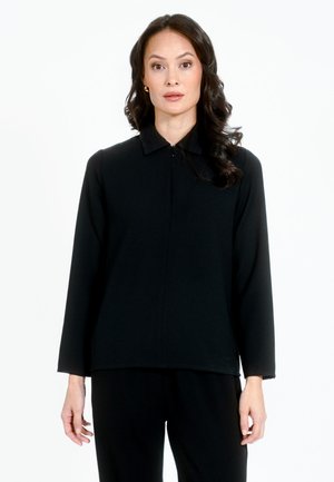 Zwarte lange mouwen top met een kraag, voorzien van een ritssluiting en een gladde, textuurstof. Eenvoudige, rechte snit en minimalistisch ontwerp.