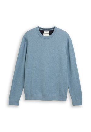 Világoskék, kerek nyakú pulóver, puha anyagból készült, hosszú ujjú, bordás mandzsetta és egyenes szegély jellemzi. Diszkrét márkajelzés található az elején.