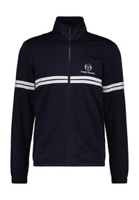 Marineblaue Zip-Jacke aus strukturiertem Stoff, mit weißen Streifen über der Brust und an den Ärmeln, und einem Logo auf der oberen linken Seite.