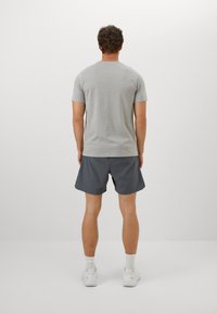 Gray short-sleeve t-shirt and dark gray shorts, both in a casual fit. The texture appears smooth, with a simple cut and minimal details.
