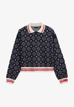 Námořnický cropped pulovr s polo límcem, zdobený zlatým diamantovým a hvězdným vzorem. Červené a bílé pruhované akcenty na lemu a manžetách.