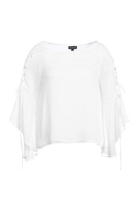Blusa bianca a maniche larghe, con un taglio ampio e dettagli con lacci sui lati. Realizzata in tessuto leggero e testurizzato.