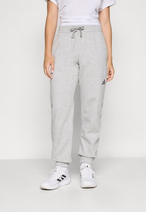 Pantalon de survêtement en coton gris avec une taille élastique, cordon de serrage et chevilles resserrées. Doté d'un logo Adidas noir sur le côté gauche.