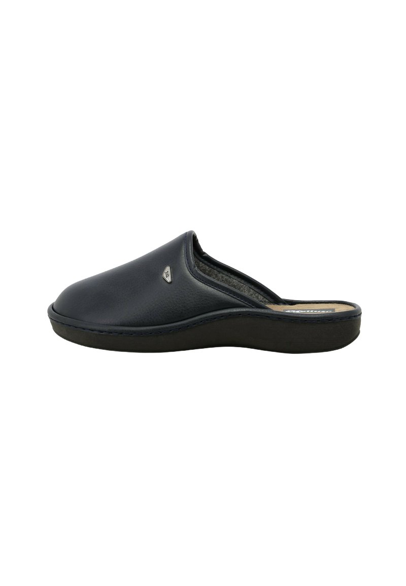Mule in pelle scamosciata blu navy con silhouette curva, soletta imbottita e suola in gomma nera. Presenta un piccolo dettaglio del logo metallico.