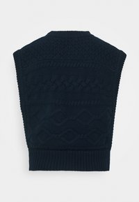 Veste tricotée bleu foncé présentant divers motifs texturés, dont des torsades et des losanges, avec un col et un ourlet côtelés.