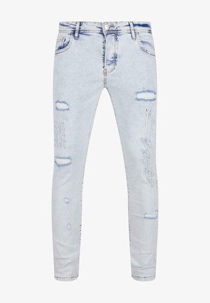 Svetlomodré riflové nohavice s úzkym strihom, zdobené poškodenými záplatami, vyšívanými detailmi a minimálnym blednutím po celom povrchu.