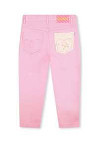 Różowe dżinsy o dopasowanym kroju, z błyszczącą kieszonką z sercowym wzorem i kolorowymi plamkami. Kieszenie z tyłu.