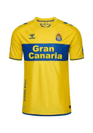 Żółta koszulka piłkarska z niebieskim paskiem na piersi, tekst "Gran Canaria", herb drużyny po lewej stronie klatki piersiowej oraz logo Hummel po prawej.
