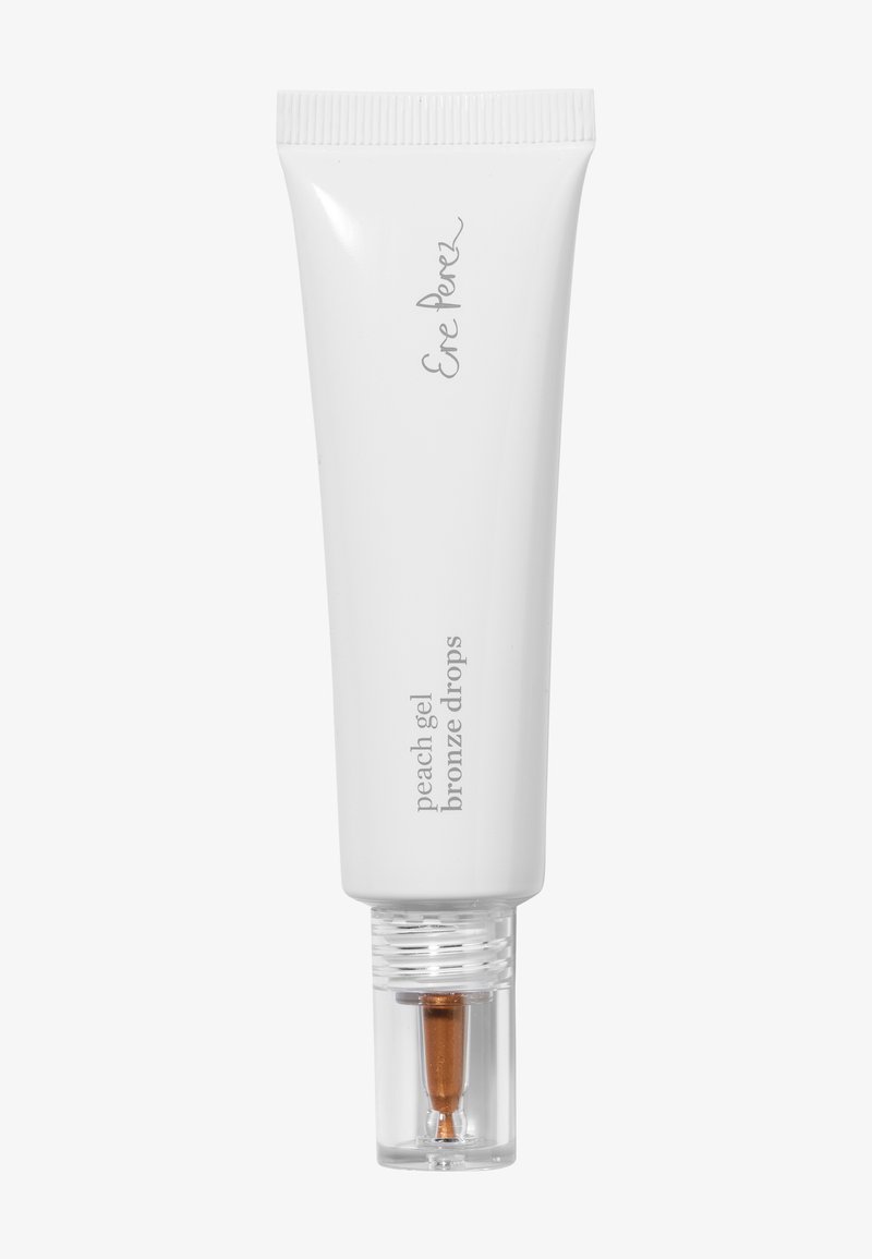 Biała tubka Eve Perez Peach Gel Bronze Drops z przezroczystą nakrętką, pokazująca bronzujący aplikator w żelu.