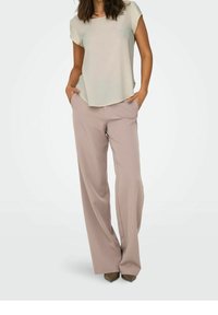 Light green short-sleeve top with a relaxed fit, paired with pale pink wide-leg trousers. Trousers feature side pockets and smooth texture.