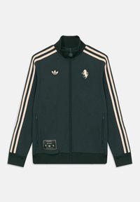 Dunkelgrüne Zip-up Trainingsjacke mit beigen drei Streifen an den Ärmeln, Adidas-Logo, Pferde-Patch und mit Reißverschluss versehenen Seitentaschen.