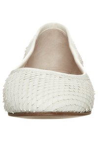White flat shoe made of textured material, featuring a scaled pattern and a smooth interior. Rounded toe and low profile design.