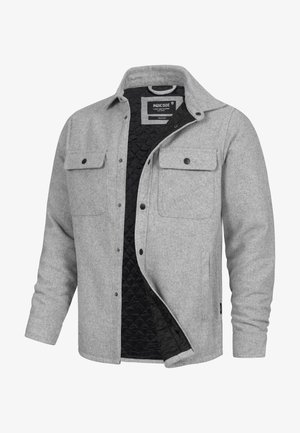 Graue Wolljacke mit gesteppter schwarzer Innenfütterung, mit Knopfleiste vorne, zwei Brusttaschen und einem lockeren Schnitt. Strukturierter Stoff.