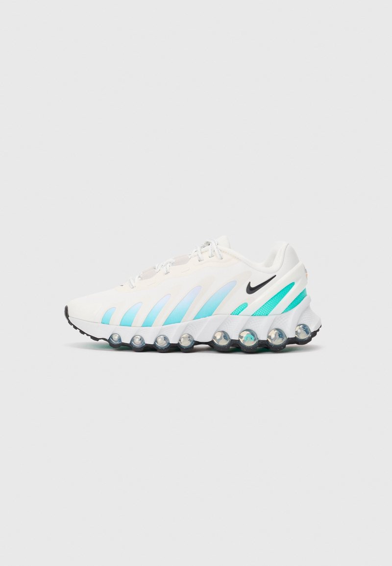 Chaussure de course Nike blanche et turquoise avec swoosh noir, semelle à bulles d'air et fermeture à lacets sur fond gris, vue de côté.