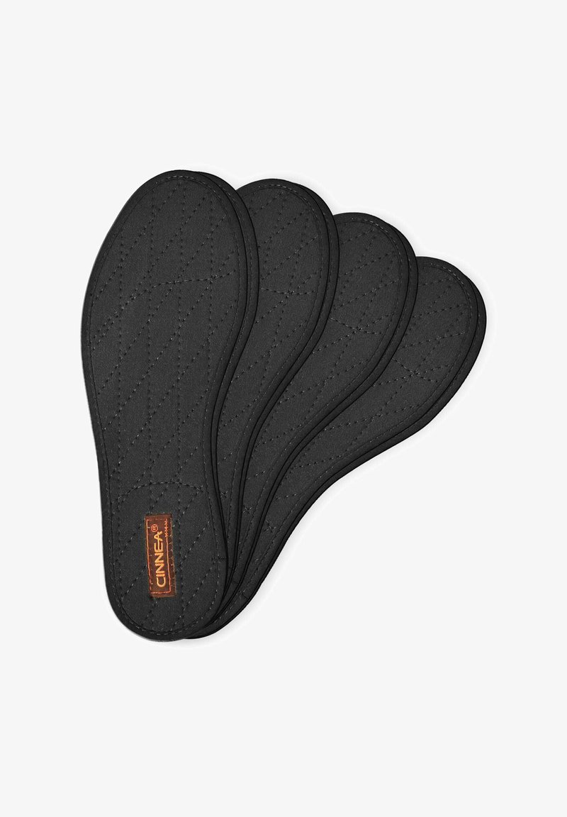 Black quilted insoles arranged in a stack, featuring a smooth texture and a small logo tag on the side.