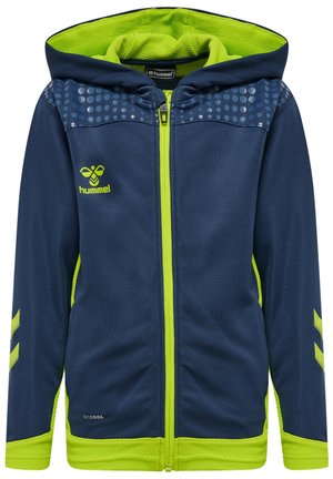 Veste zippée à capuche bleu marine avec des accents vert fluo, un design texturé et un motif à pois sur les épaules. Logo Hummel sur la poitrine.