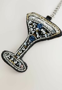 Beaded cocktail glass charm with black felt base, featuring silver, gold, and blue sequins in a decorative pattern. Chain attachment included.