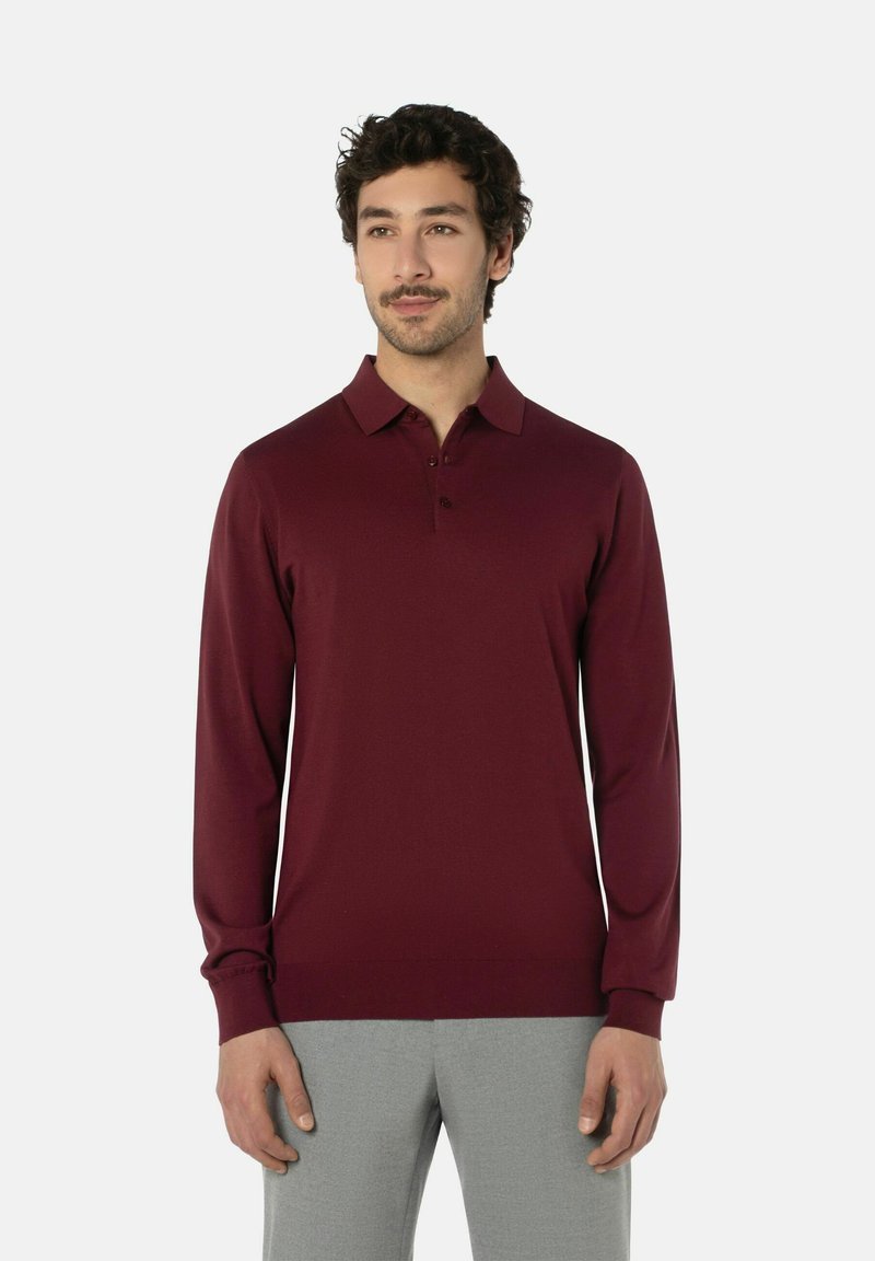Bordeauxfarbiges Langarm-Polo-Shirt mit Kragen, Knopfleiste mit zwei Knöpfen und gerippten Bündchen. Weicher, glatter Stoff mit taillierter Silhouette.