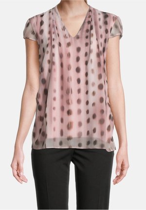 Blouse en voile rose avec un col en V et des manches courtes. Présente un motif à pois marron foncé. Coupe ample, tissu léger.