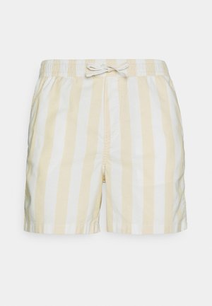 Pantaloncini a righe giallo chiaro e bianco con vita elasticizzata e dettaglio con laccio. Realizzati in tessuto morbido, con un taglio casual.