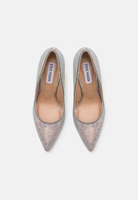 Scarpe con tacco a punta ricoperte di strass multicolori, con un interno nude liscio e il marchio Steve Madden sulla soletta.