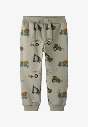 Pantalones deportivos beige para niños con puños elásticos y cordón, con un patrón de vehículos de construcción coloridos que incluyen excavadoras y mezcladoras de cemento.