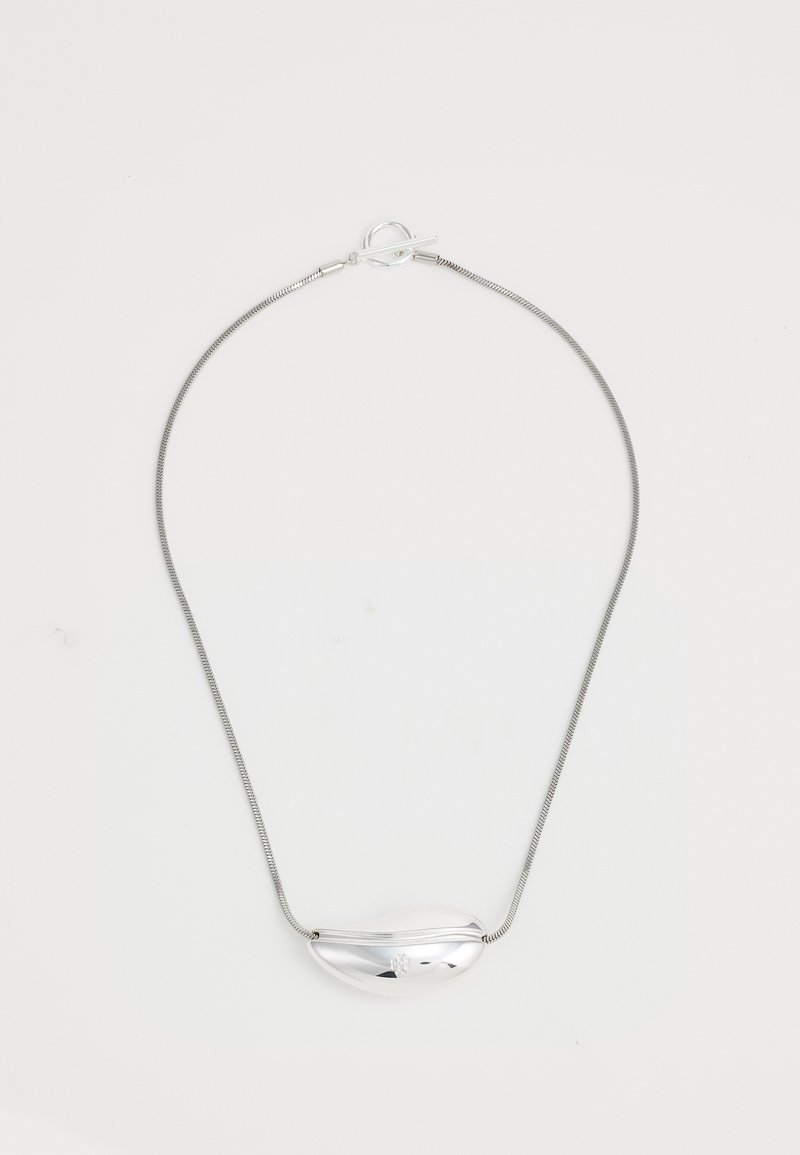 Silver metal necklace with a smooth, bean-shaped pendant, suspended from a thin, flexible chain with a toggle clasp.