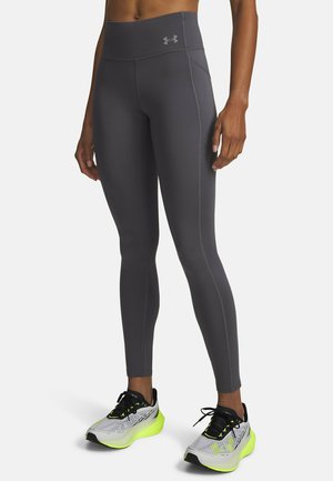 Hooggetailleerde, nauwsluitende legging in donkergrijs met contrasterende stiknaden. Voorzien van een logo op de tailleband en een gladde, rekbare stof.