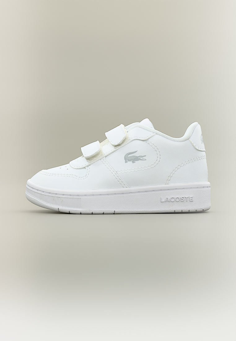 Бяла ниска маратонка с две велкро презрамки, логото на Lacoste отстрани и тесненото име на марката на външния ръб на подметката.