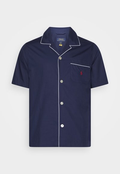 Short-sleeve navy shirt with white piping, button closure, and a chest pocket featuring a red logo. Made of a smooth, lightweight fabric.