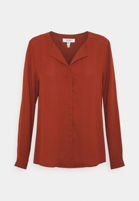 Blouse à manches longues de couleur rouille, confectionnée dans un tissu léger avec un décolleté en V et une coupe décontractée, présentant un design de patte de boutonnage avant épuré.