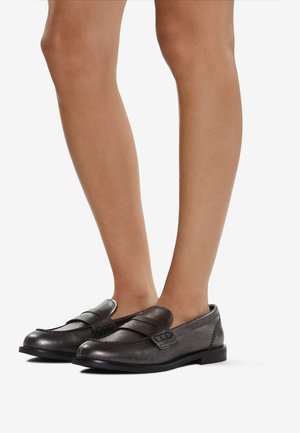 Dark gray leather loafers with a rounded toe, featuring a decorative strap across the vamp and subtle stitching details. Low heel design.