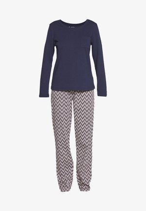 Navy long-sleeve top with a chest pocket, paired with chevron-patterned cream and black elasticized pajama pants.