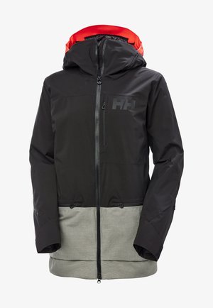 Chaqueta impermeable negra con una sección inferior gris en contraste, presenta un cierre de cremallera en la parte frontal, capucha ajustable y detalle del logo en el pecho.